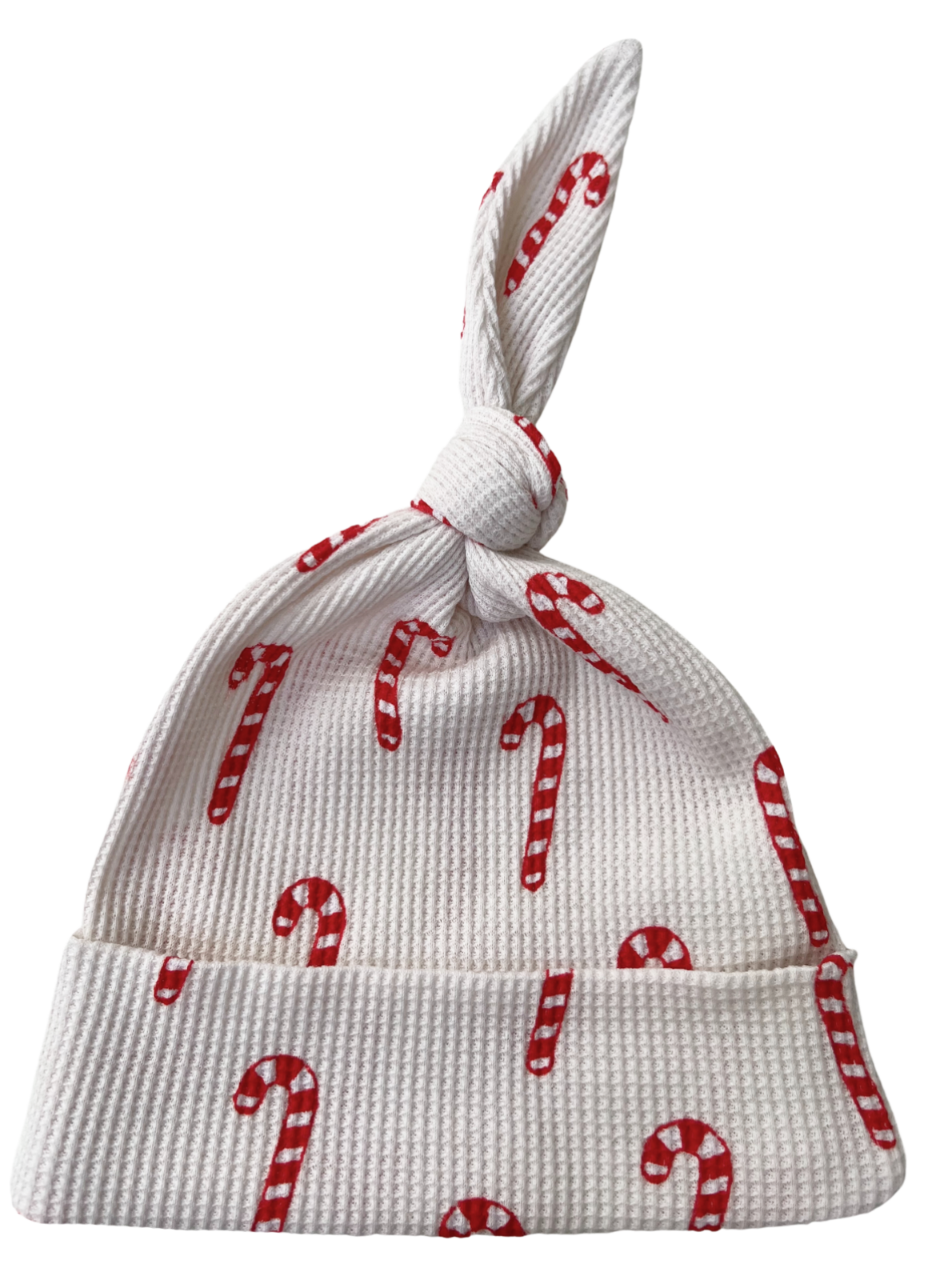 White baby hat with red candy cane pattern and a tied top. Perfect for holiday celebrations.