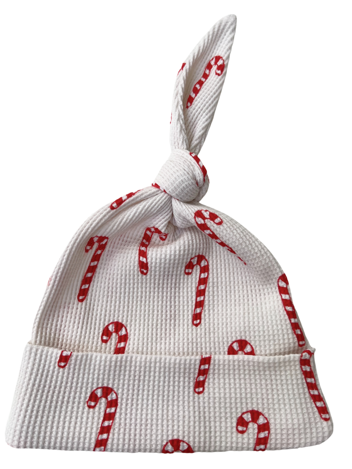 White baby hat with red candy cane pattern and a tied top. Perfect for holiday celebrations.