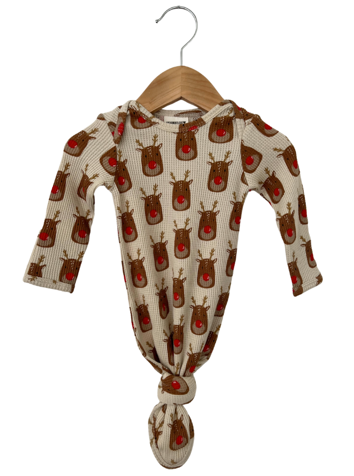 Baby sleeper with reindeer pattern, hood, and knotted bottom, hanging on a wooden hanger. Perfect for festive occasions.