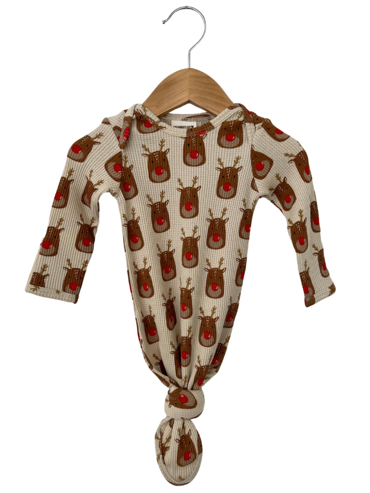 Baby sleeper with reindeer pattern, hood, and knotted bottom, hanging on a wooden hanger. Perfect for festive occasions.