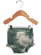 Green tie-dye ruffled baby shorts hanging on a wooden clothes hanger.