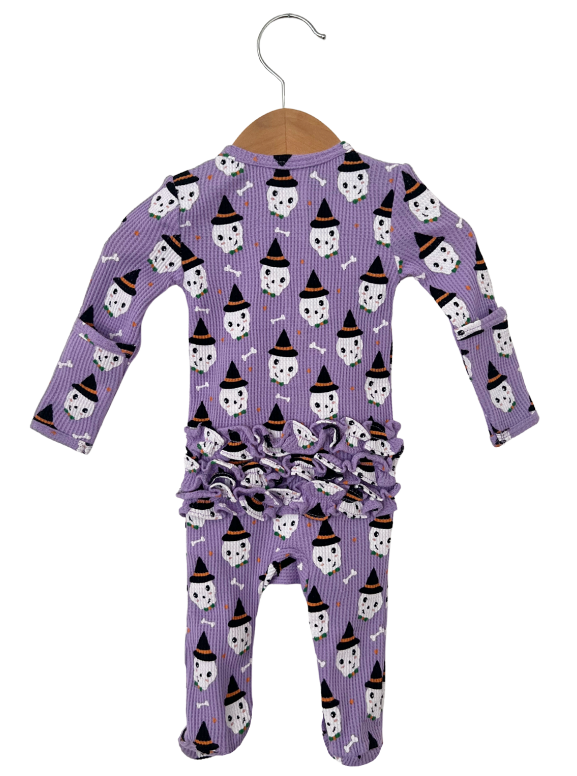 Purple infant pajamas with ghost and bone print, featuring a ruffled design at the waist.