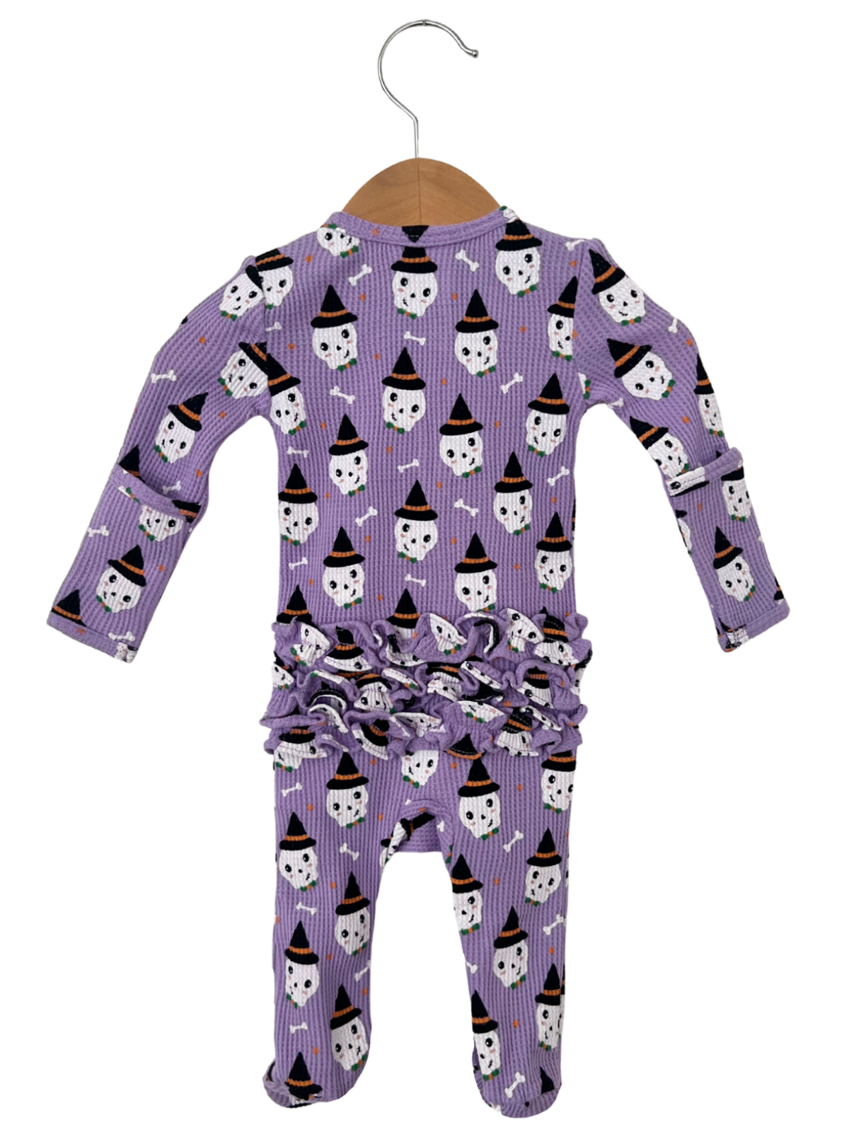 Purple infant pajamas with ghost and bone print, featuring a ruffled design at the waist.