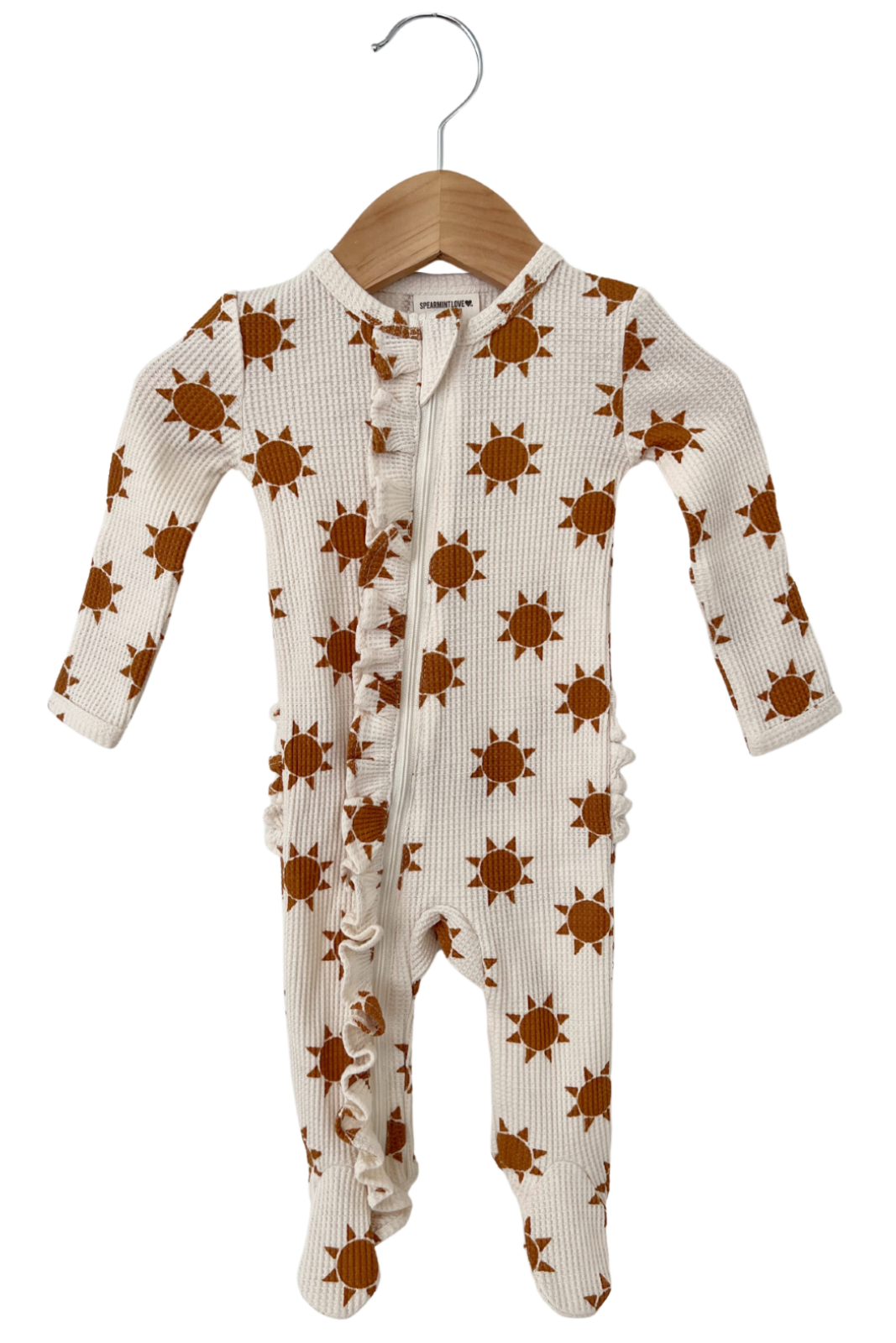 Brown sun-patterned baby onesie on a wooden hanger against a white background.
