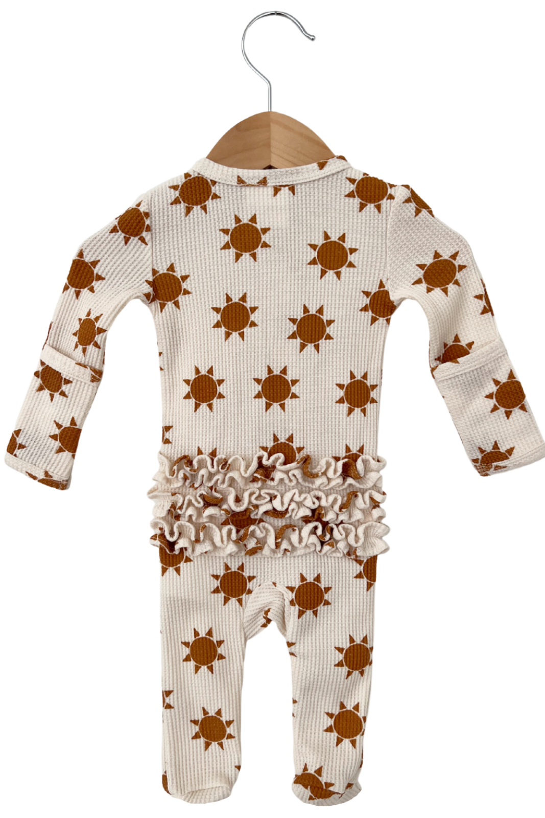 Baby onesie with orange sun pattern and ruffled trim, hanging on a wooden hanger against a white background.