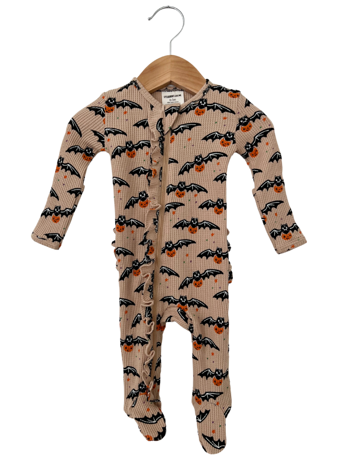 Baby onesie with bat and pumpkin print, hanging on a wooden hanger against a white background.