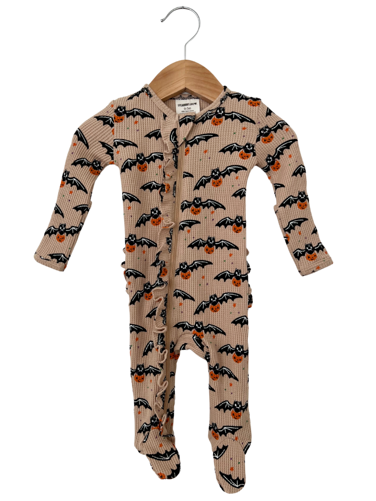 Baby onesie with bat and pumpkin print, hanging on a wooden hanger against a white background.
