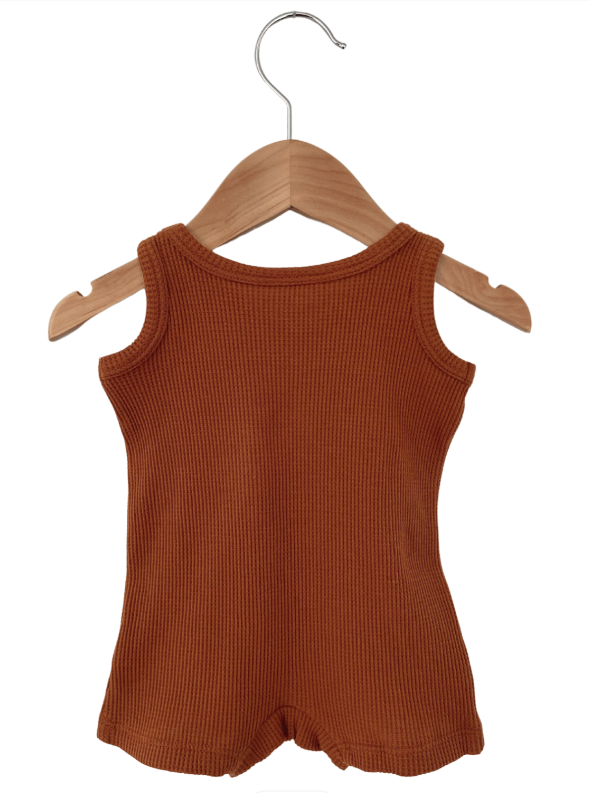 Rust-colored sleeveless ribbed top hanging on a wooden hanger against a white background.