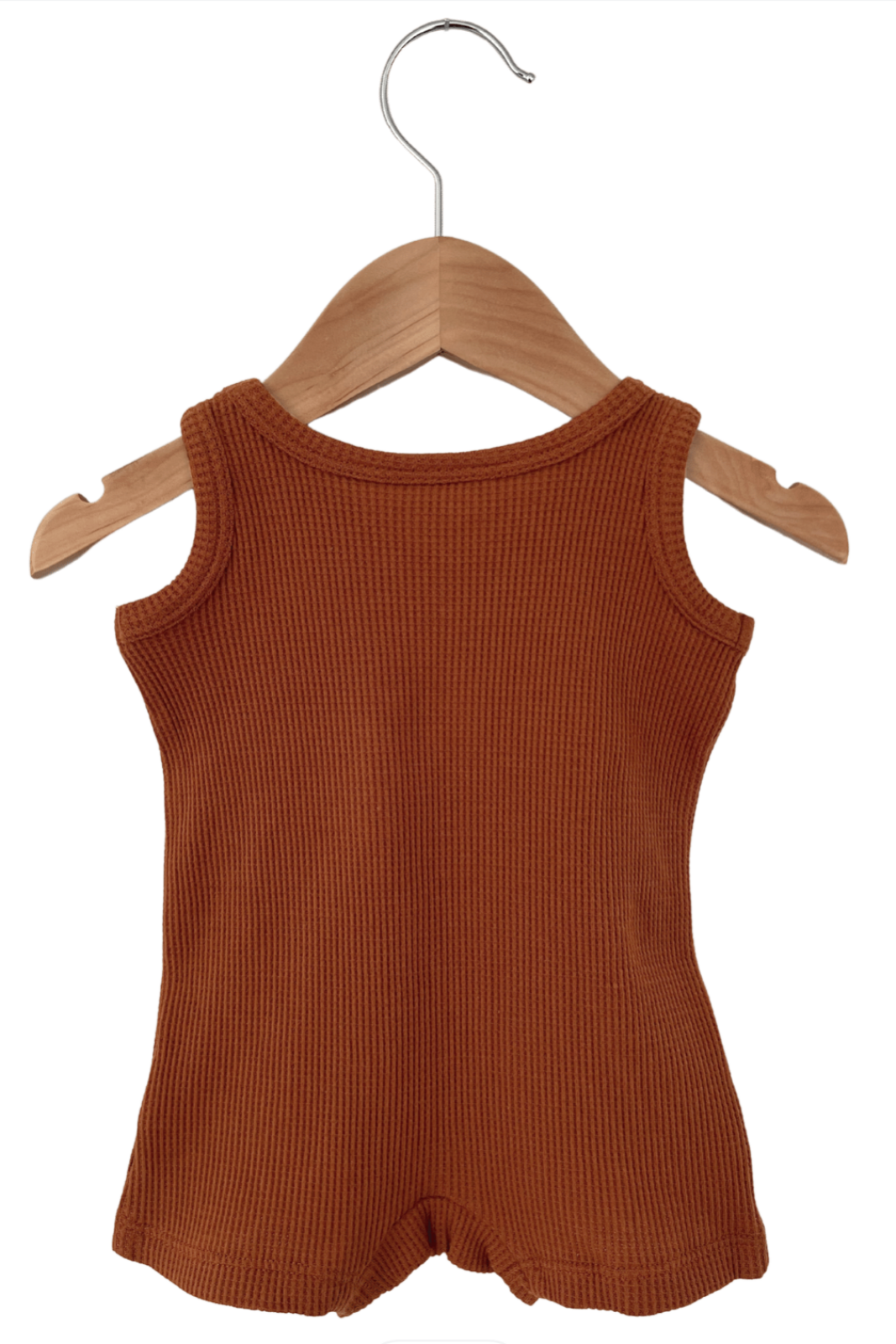 Rust-colored sleeveless ribbed top hanging on a wooden hanger against a white background.