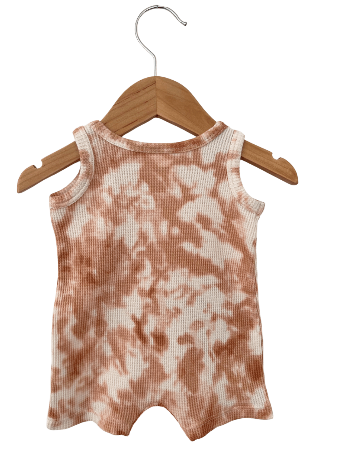 Light orange and cream tie-dye sleeveless romper hanging on a wooden hanger.