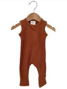 Rust orange ribbed baby romper hanging on a wooden hanger against a white background.
