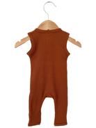 Rust-colored baby romper hanging on a wooden hanger, showcasing a ribbed texture and sleeveless design.