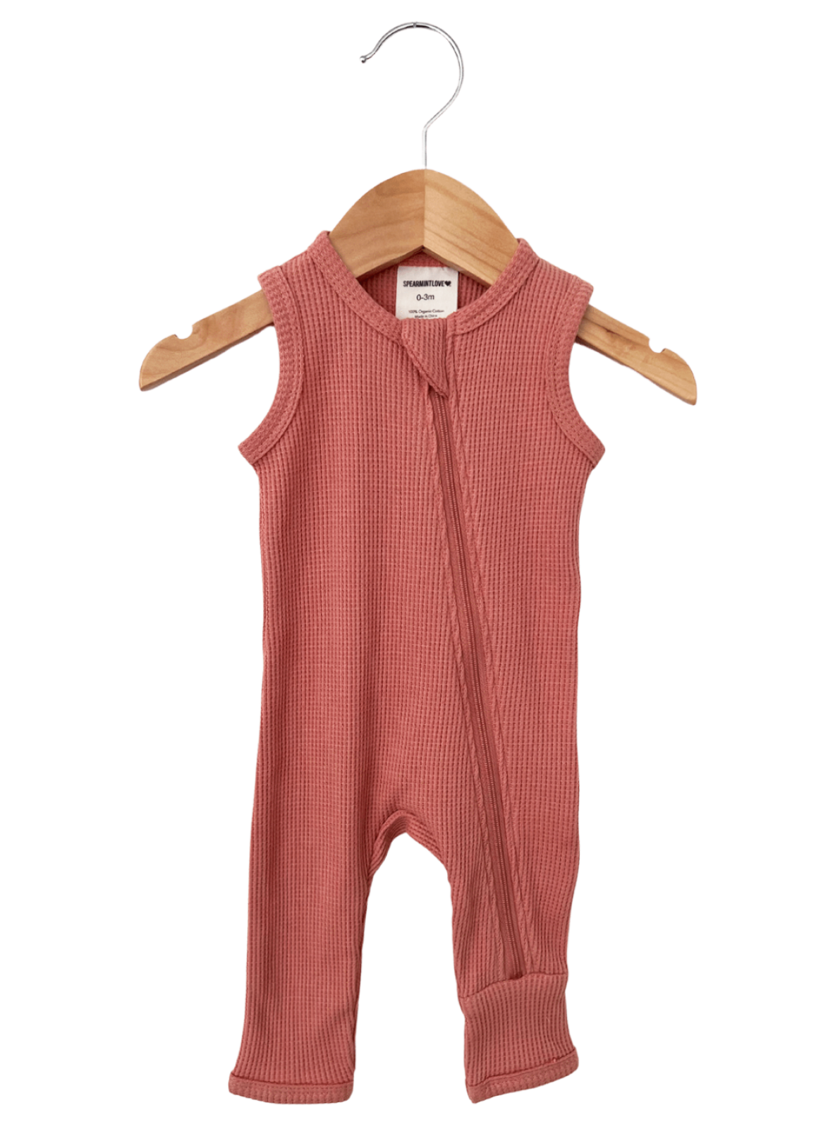 Light pink sleeveless infant romper with a front zipper, hanging on a wooden hanger.
