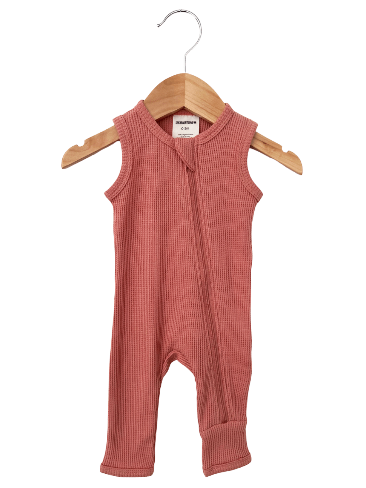 Light pink sleeveless infant romper with a front zipper, hanging on a wooden hanger.