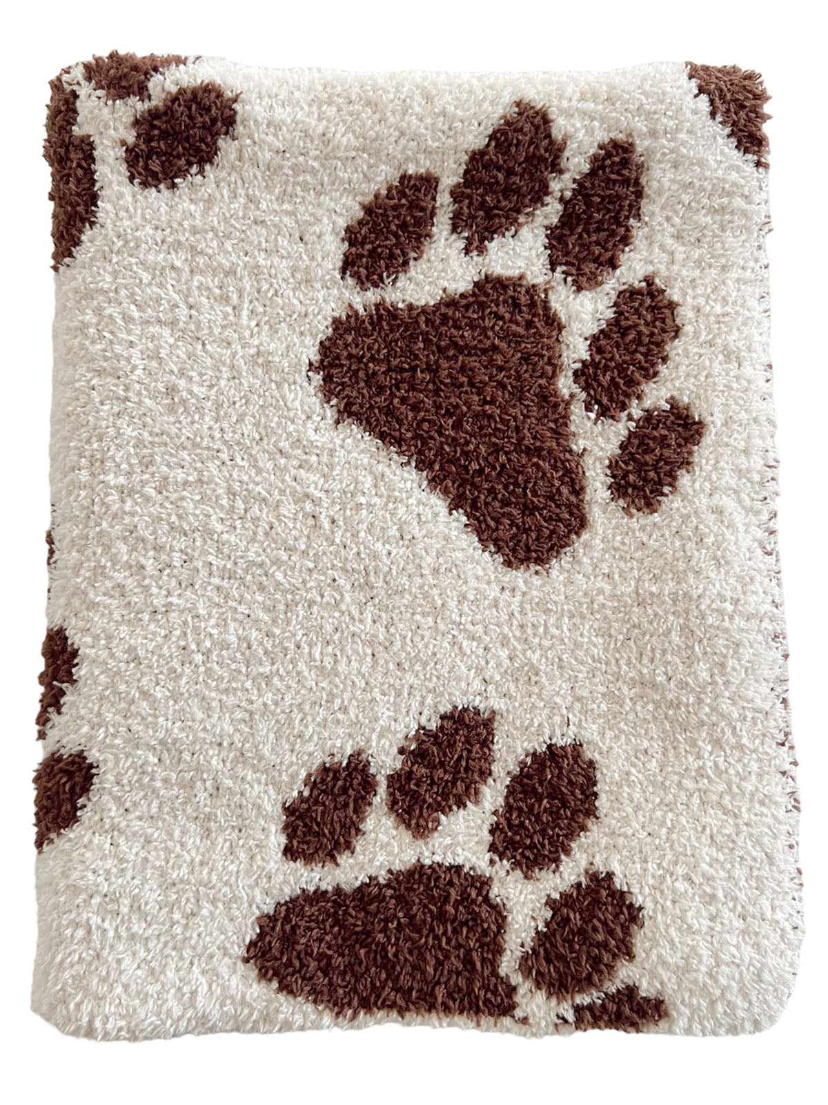 Cream-colored blanket with brown paw print patterns on a soft, textured surface.