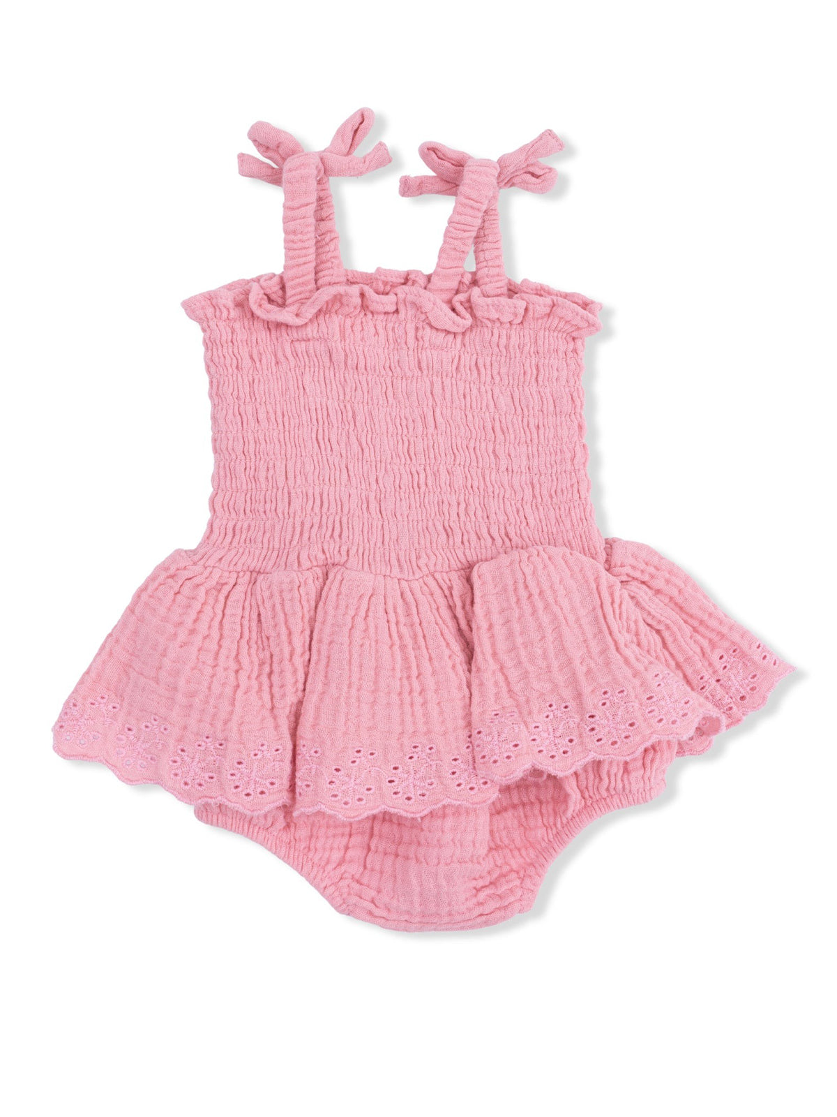 Pink girls' romper with ruffled straps and skirt; made of soft, textured fabric. Ideal for warm weather.
