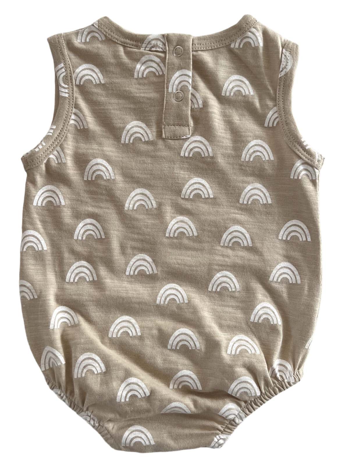 Tan baby romper with white rainbow prints, featuring a button closure at the back and elasticized leg openings.
