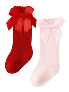 Two pairs of knee-high socks: one red with a large bow and one pink with a smaller bow, both stylish and festive.
