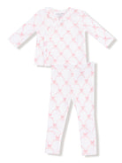 White and pink patterned children's pajama set with long sleeves and leggings.