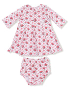 Pink floral dress with long sleeves and matching bloomers, featuring bows and a classic cut. Ideal for young girls.