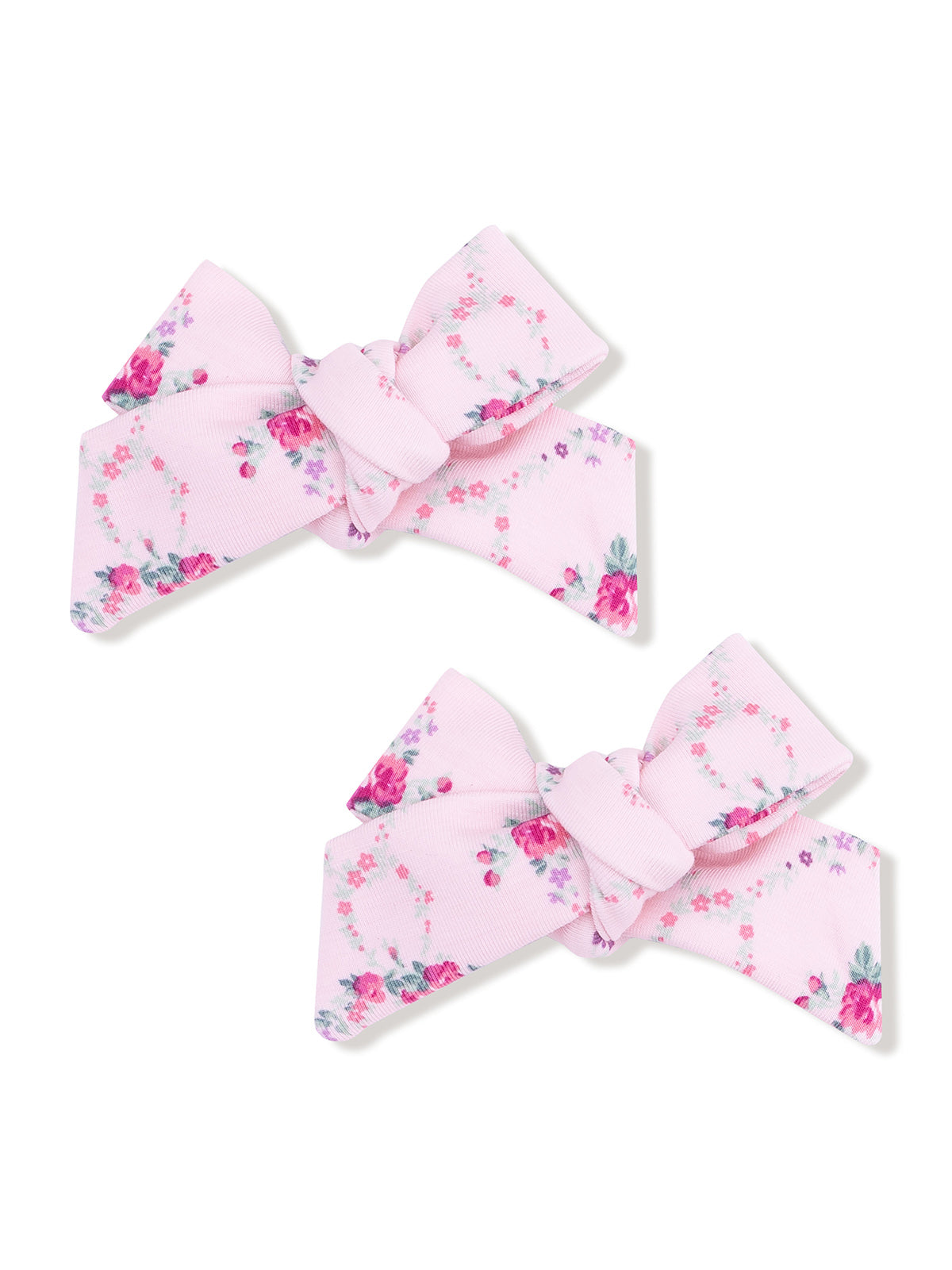 Two pink floral hair bows with a decorative knot design.