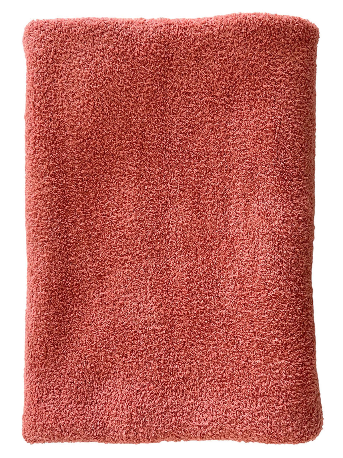 Soft, coral-colored towel folded neatly, showcasing its plush texture. Ideal for bath or kitchen use.