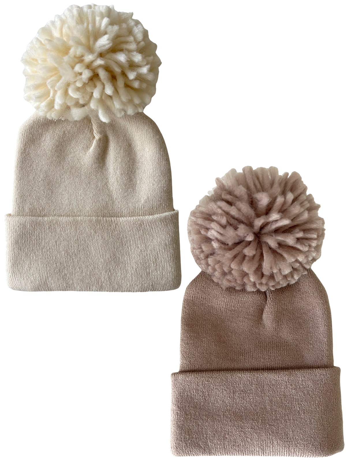 Two cozy knit beanies with large pom-poms, one cream and one light pink, displayed side by side.