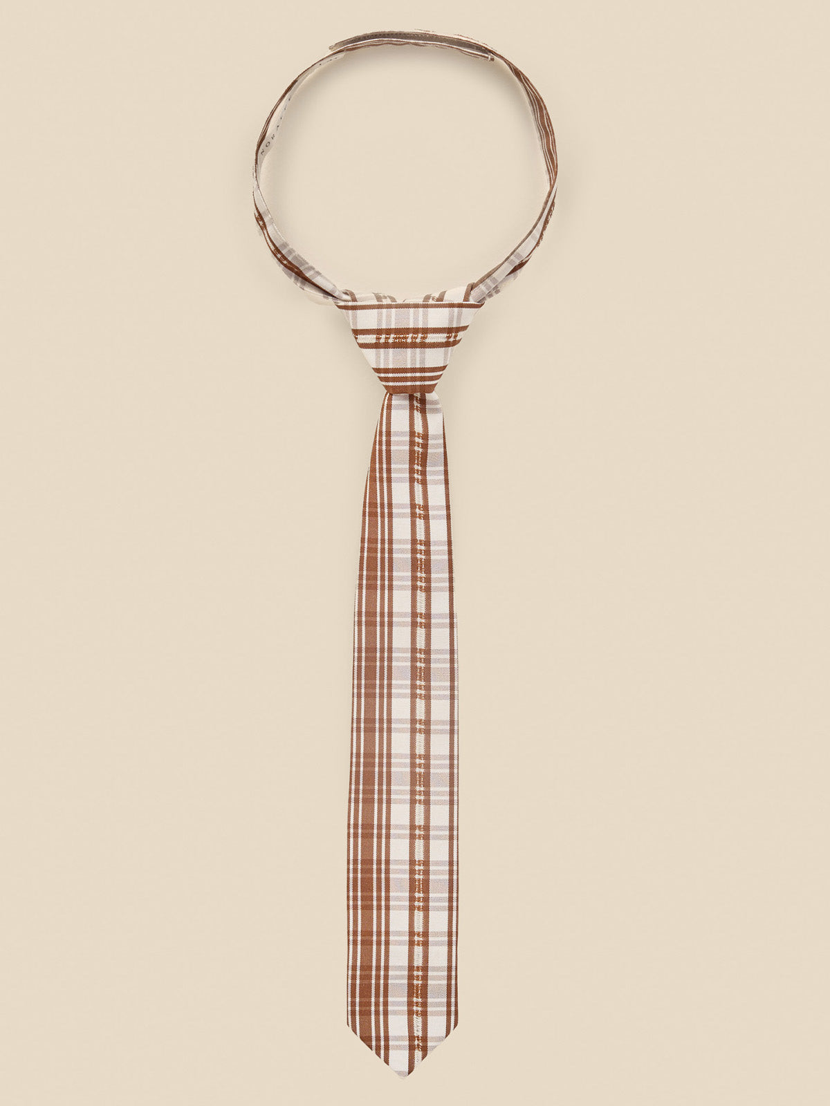 Brown and white plaid tie displayed against a neutral background.