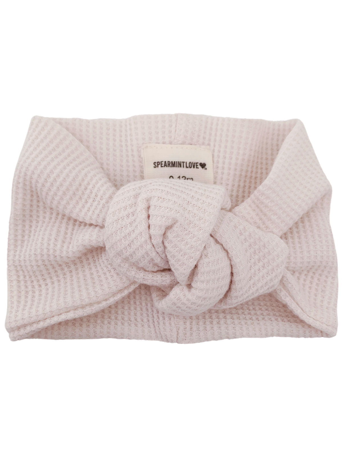 Light pink knot headband with textured fabric, labeled 'SPEARMINTLOVE.' Perfect for infants.
