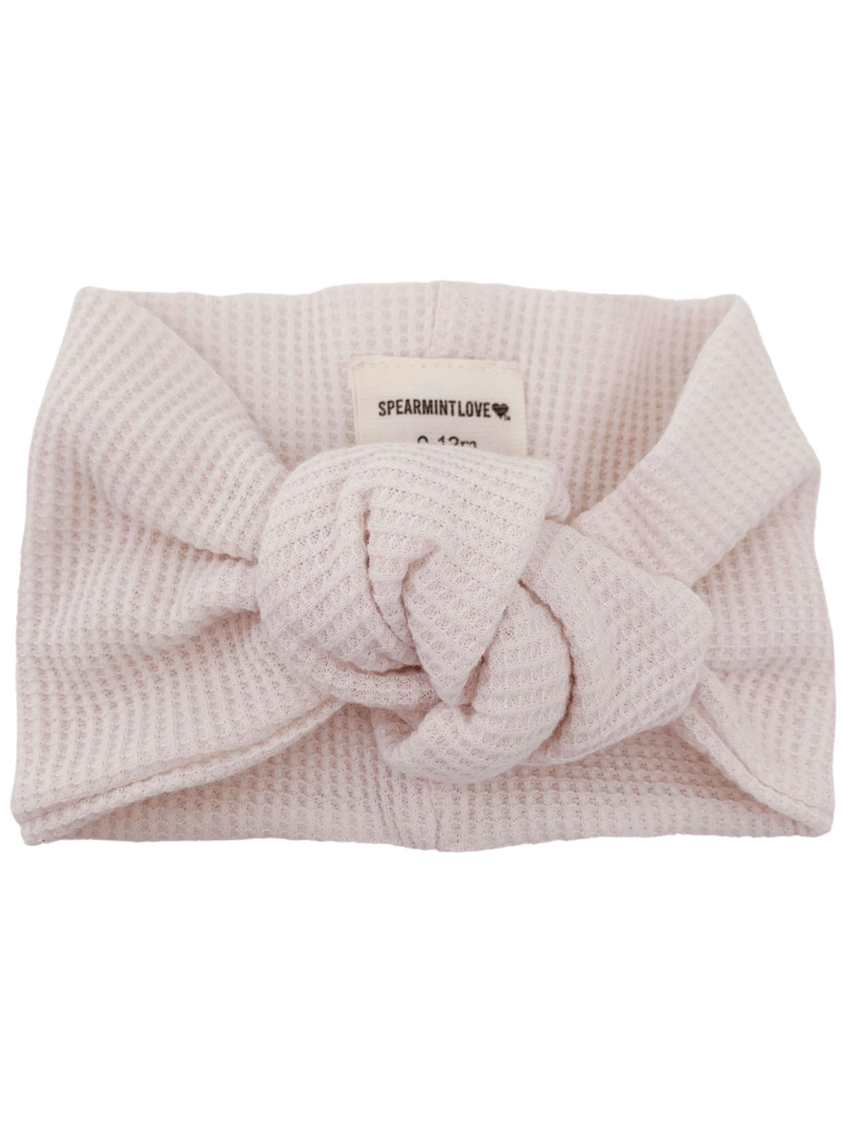 Light pink knot headband with textured fabric, labeled 'SPEARMINTLOVE.' Perfect for infants.