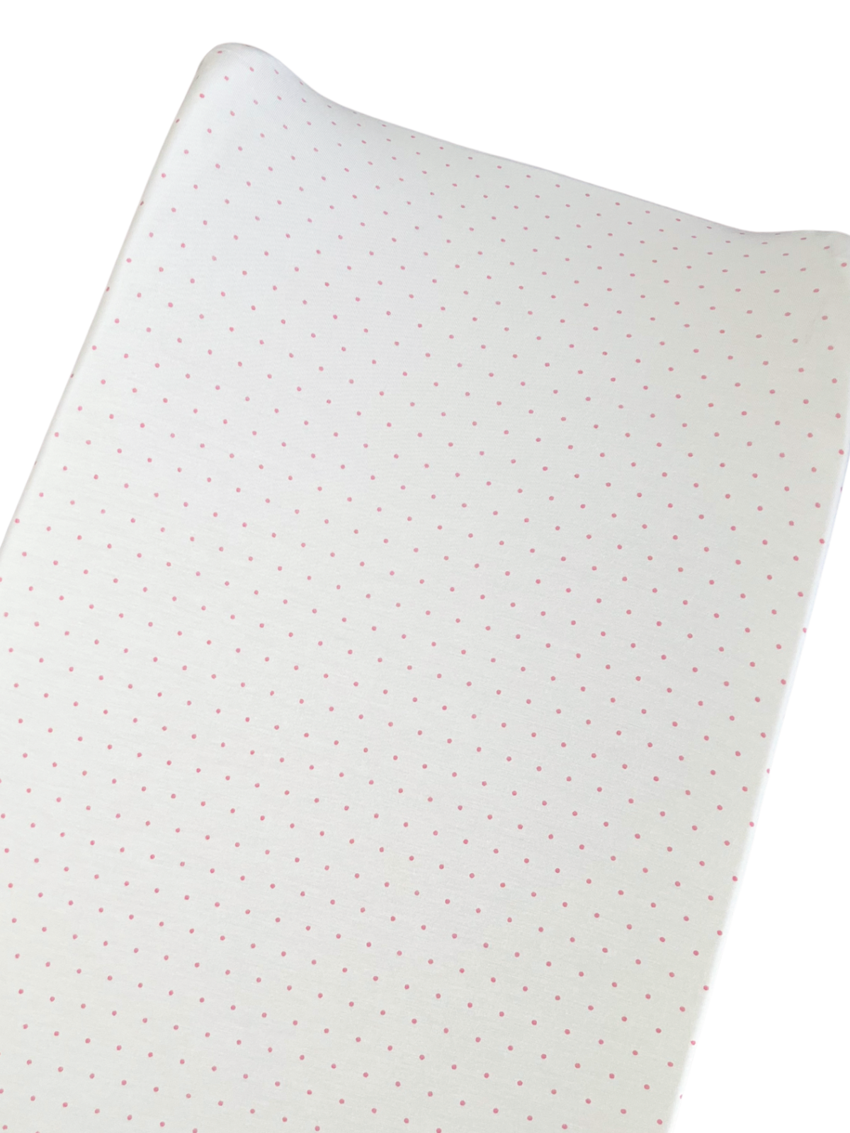 White fabric with small pink polka dots, draped and partially rolled.