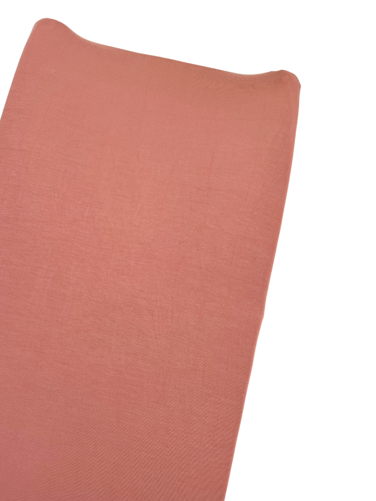Soft, textured fabric in a warm pink hue draped elegantly.