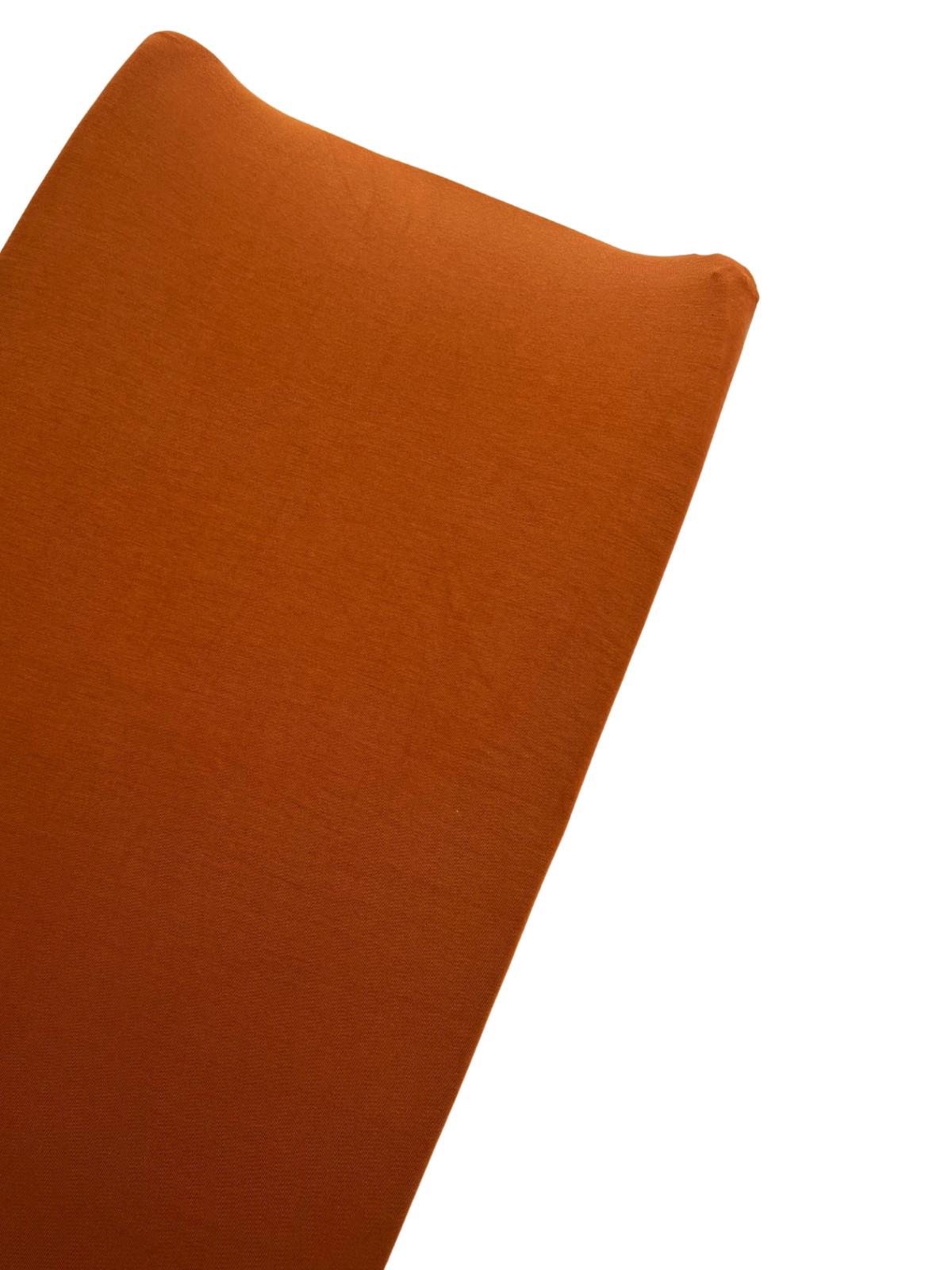 Orange fabric draped over a surface, highlighting its smooth texture and rich color.