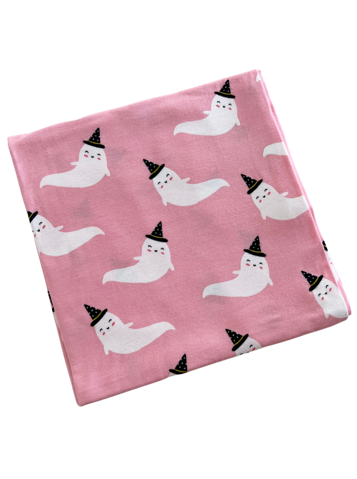 Pink fabric featuring cute, smiling ghosts wearing black party hats in a repeating pattern.