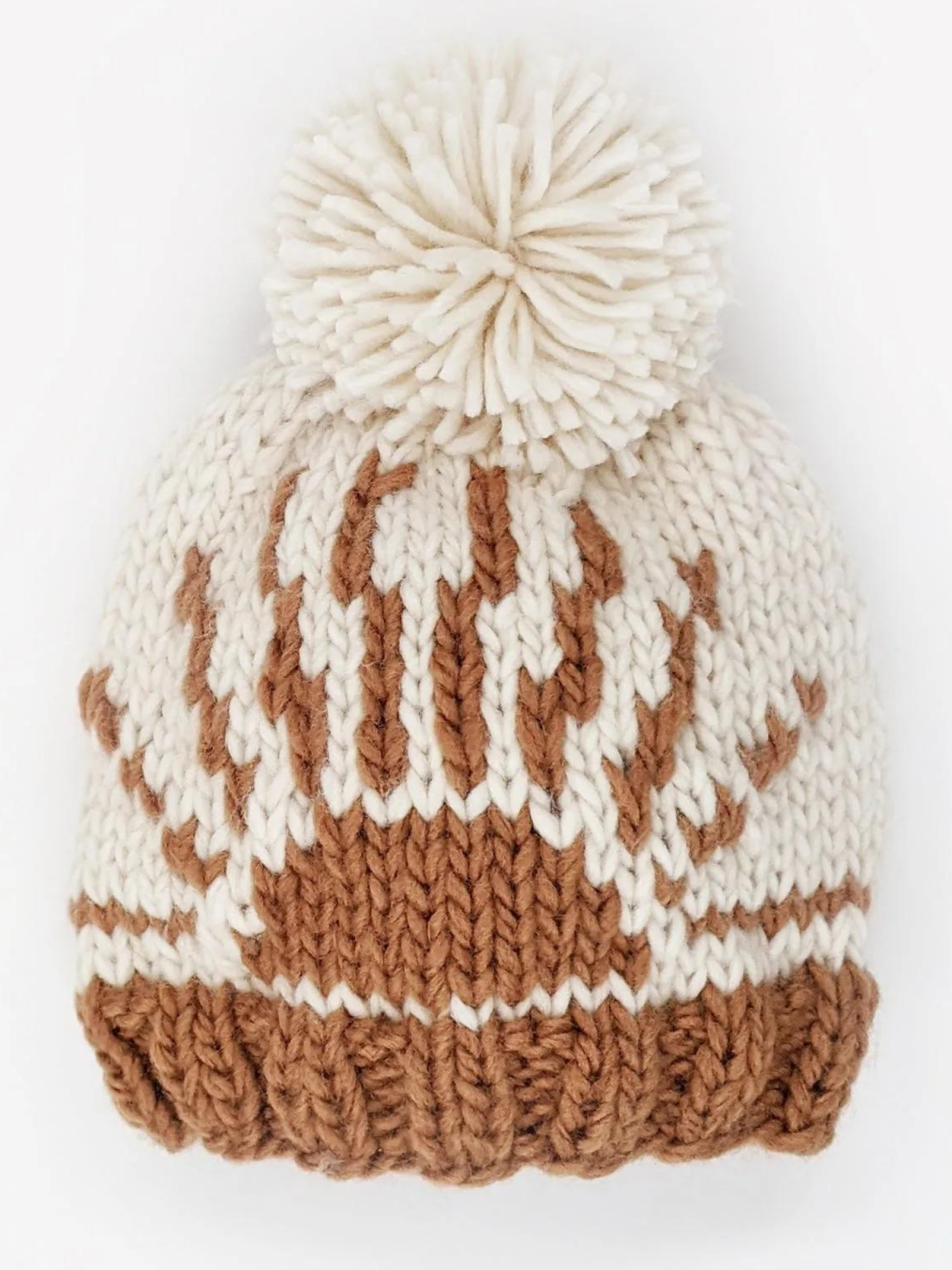 Knitted beige and brown beanie with a pom-pom and sun-like design at the crown.