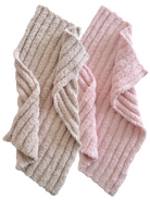 Two soft, textured towels, one in beige and the other in light pink, displayed together.
