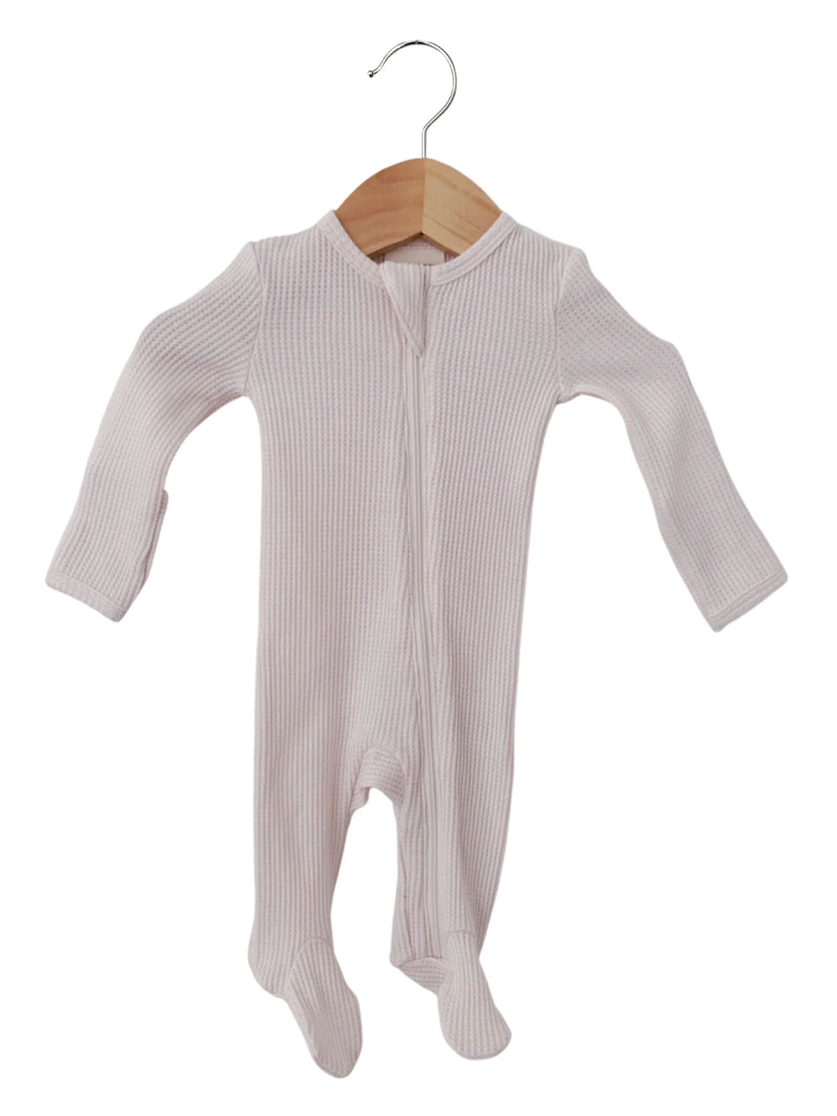 Light pink baby onesie hanging on a wooden hanger, featuring long sleeves and footie design.