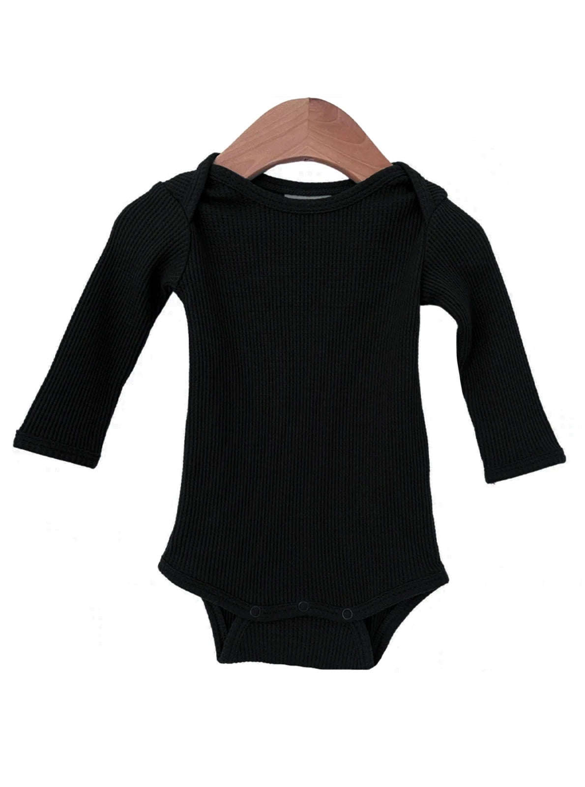 Black long-sleeve baby bodysuit on a wooden hanger against a white background.