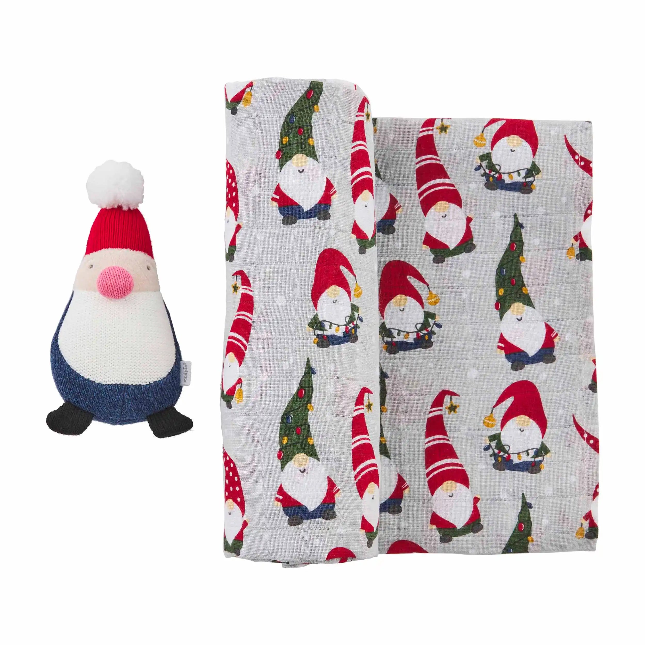 Plush gnome toy beside a fabric featuring festive gnome patterns on a light gray background.
