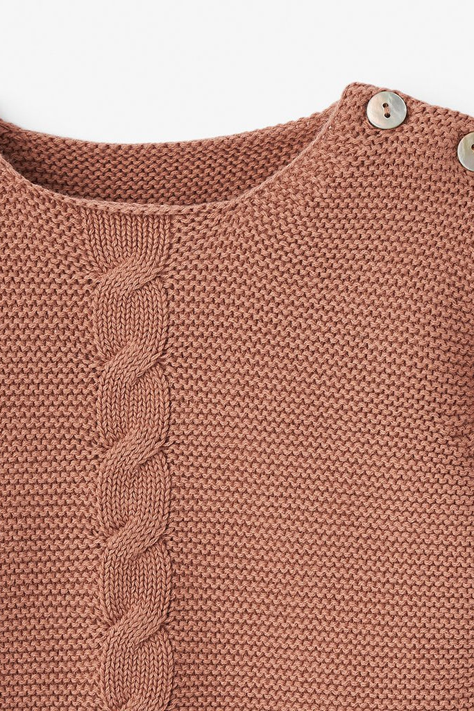 Brown knit sweater with a cable pattern and decorative buttons at the shoulder.