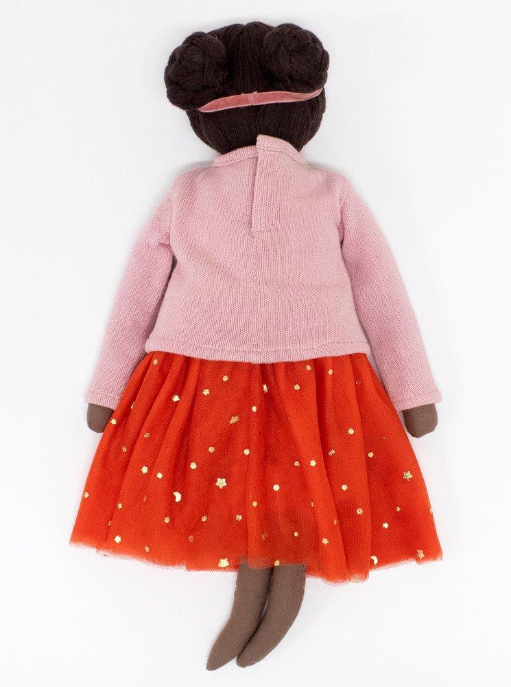 Soft doll with brown skin, wearing a pink top and an orange tulle skirt adorned with gold stars.