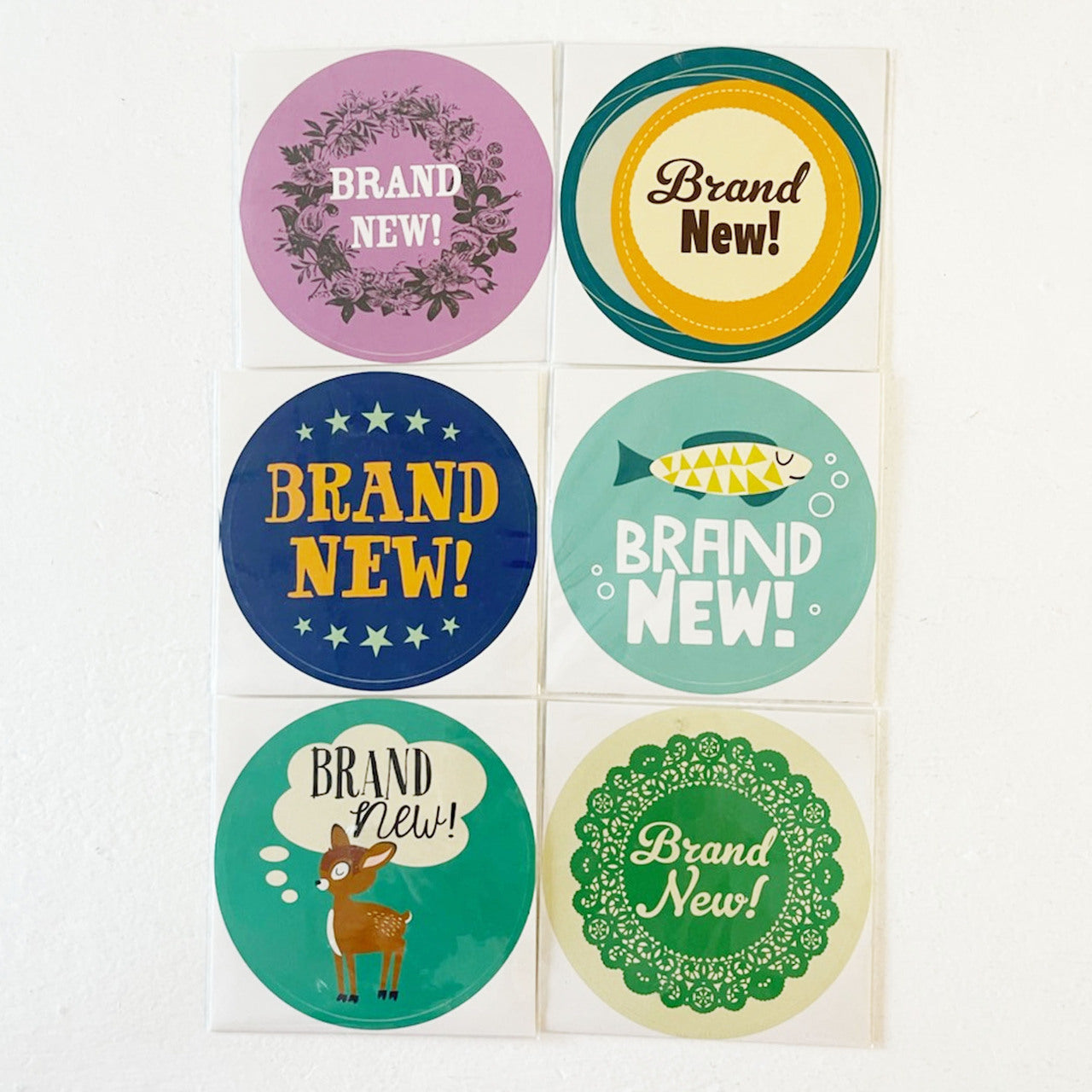 Colorful "Brand New!" stickers in various designs, arranged in a 2x3 grid on a white background.
