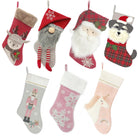 Seven festive holiday stockings featuring various designs, including Santa, a deer, and a unicorn.