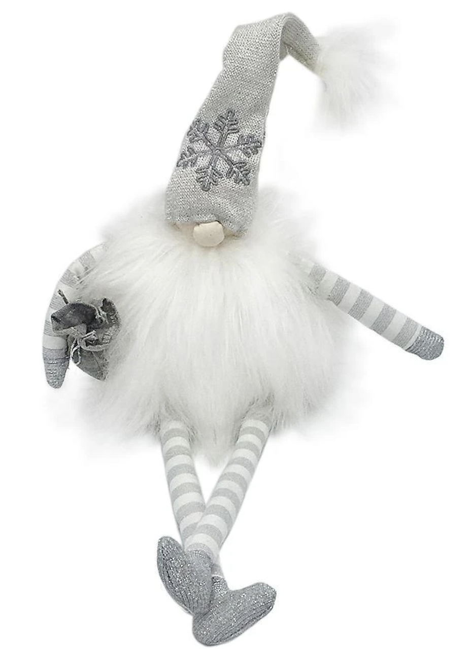 A whimsical white gnome with a silver hat, striped legs, and a fluffy body, holding a small gift.