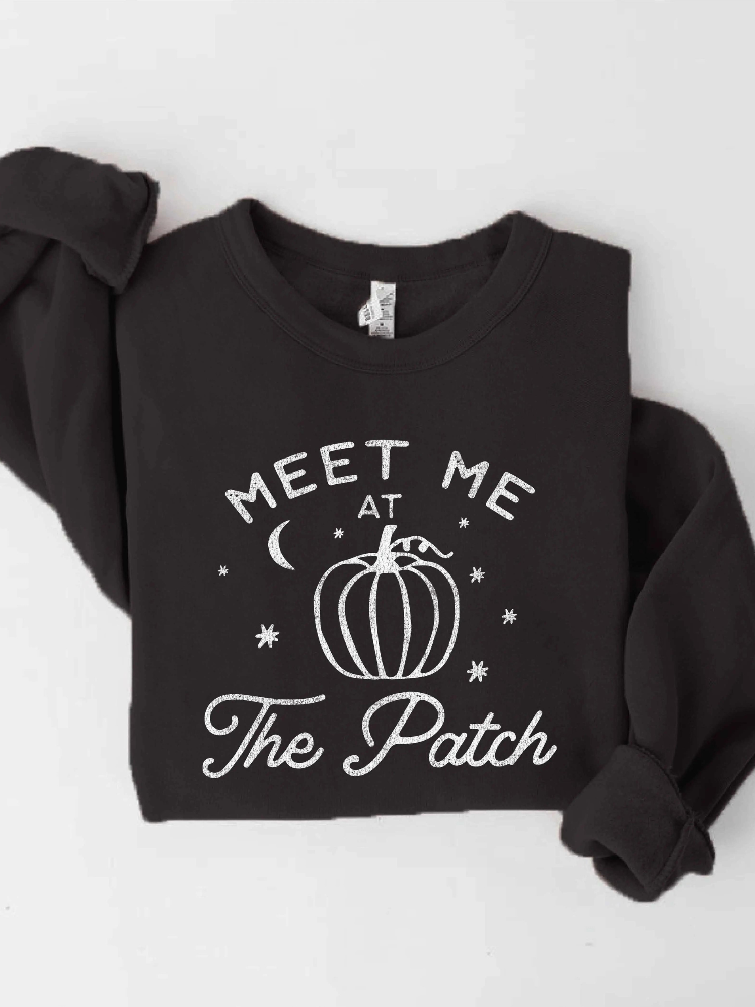Black sweatshirt with "Meet Me at The Patch" text and pumpkin graphic. Perfect for fall gatherings.
