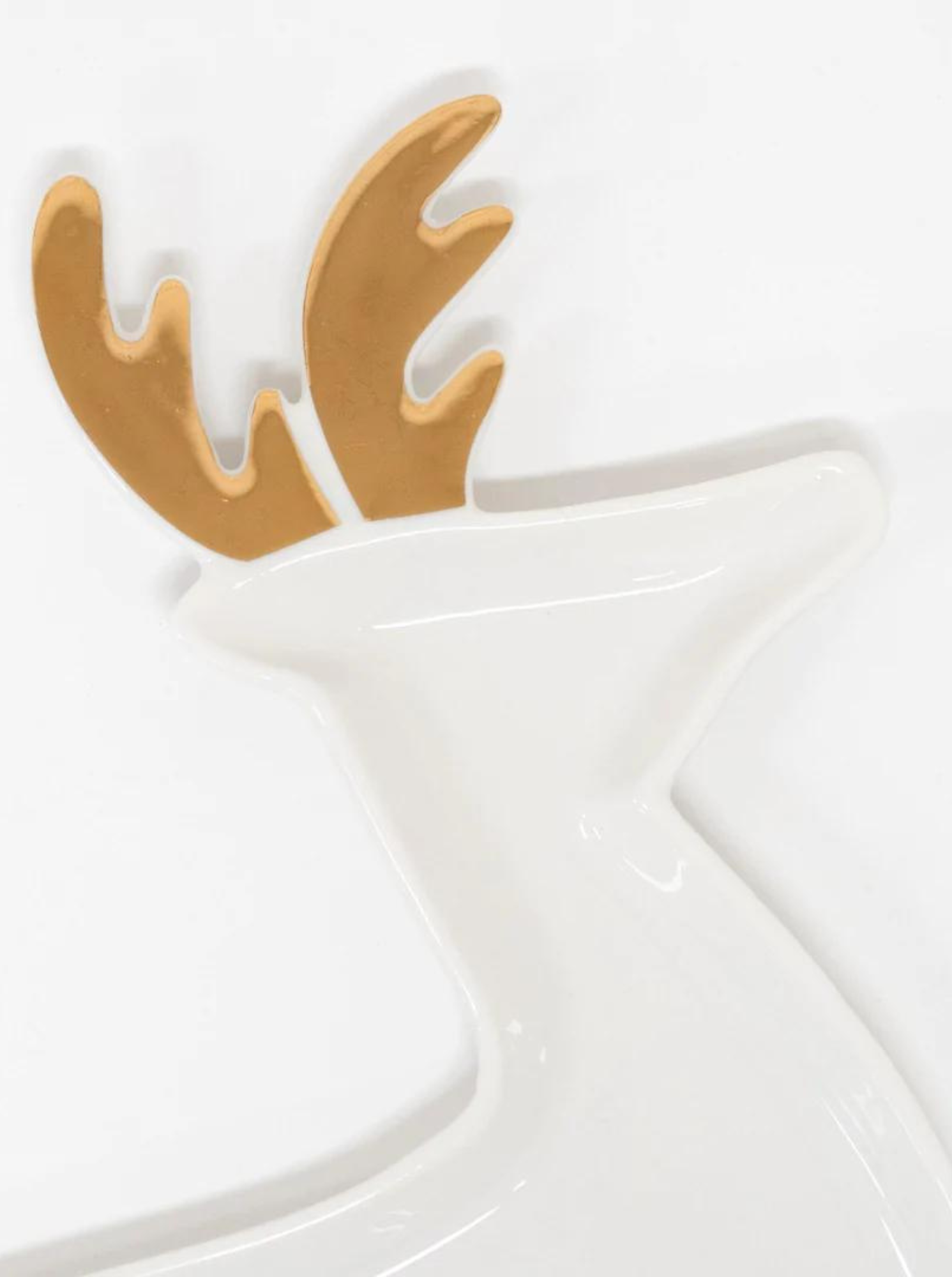 White dish shaped like a reindeer with gold antlers, ideal for decorative or serving purposes.