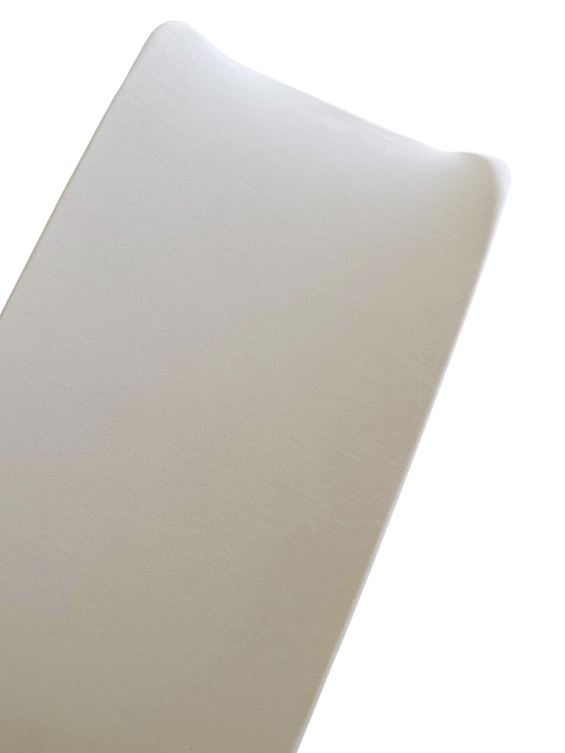 Close-up of a smooth, beige foam mattress corner on a white background.