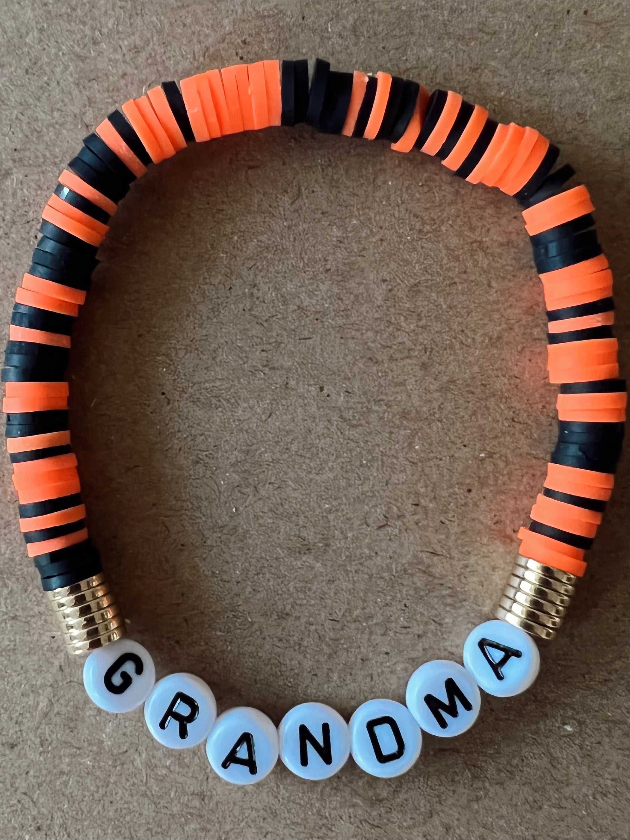 Colorful beaded bracelet with the word "GRANDMA" spelled in white letters.