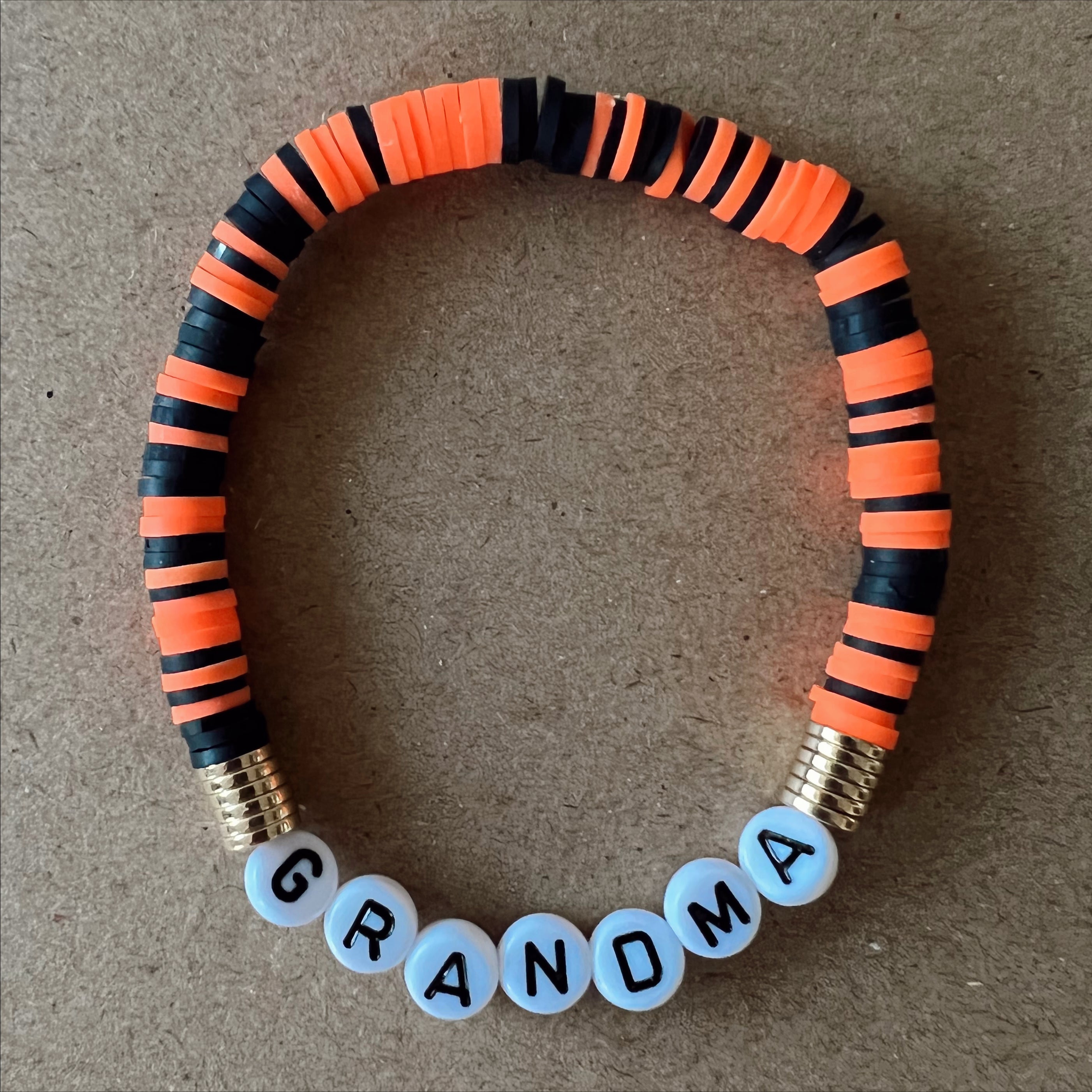 Colorful beaded bracelet with the word "GRANDMA" spelled in white letters.