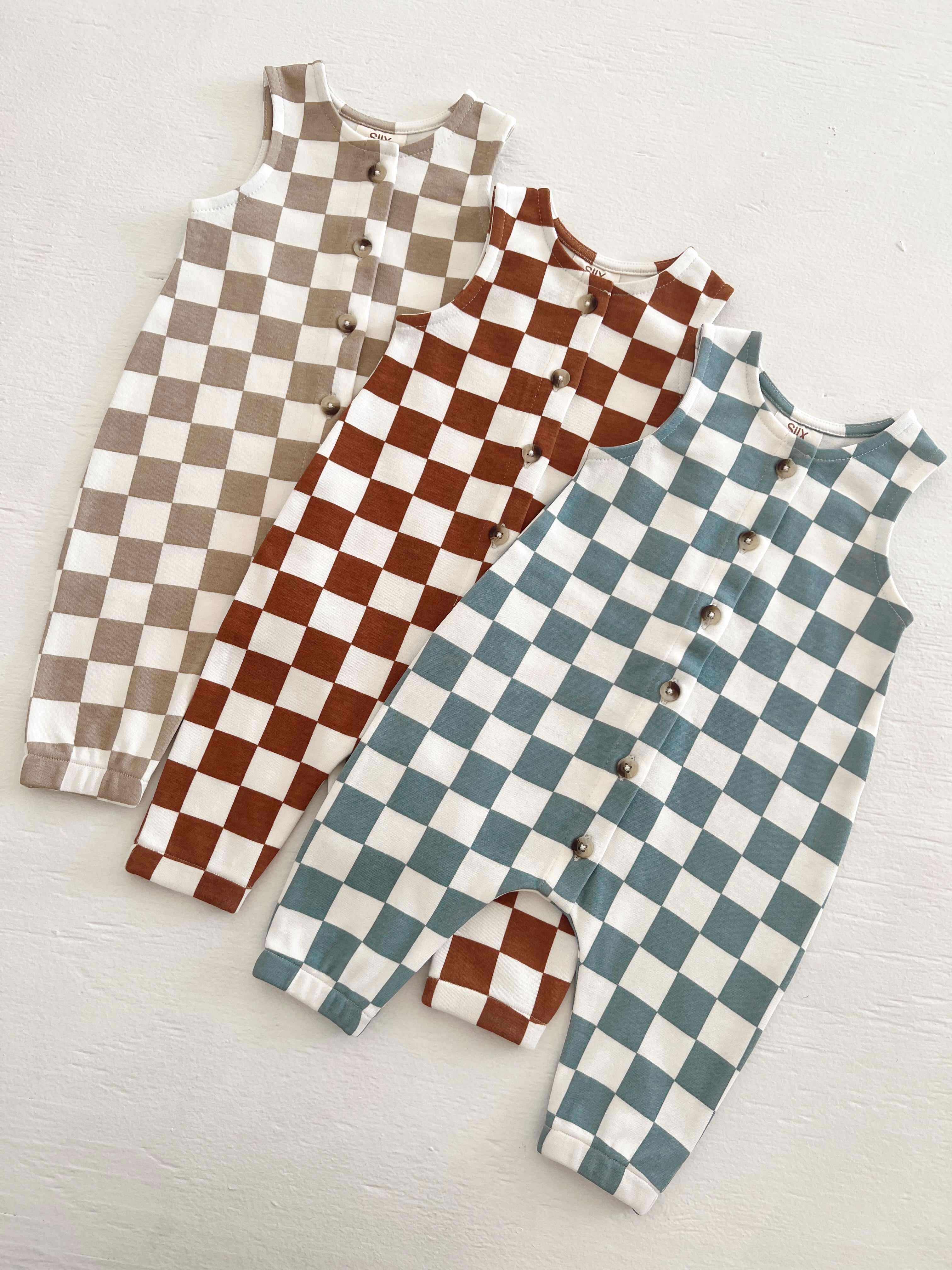 Three checkered baby rompers in beige, brown, and teal, displayed on a light background.